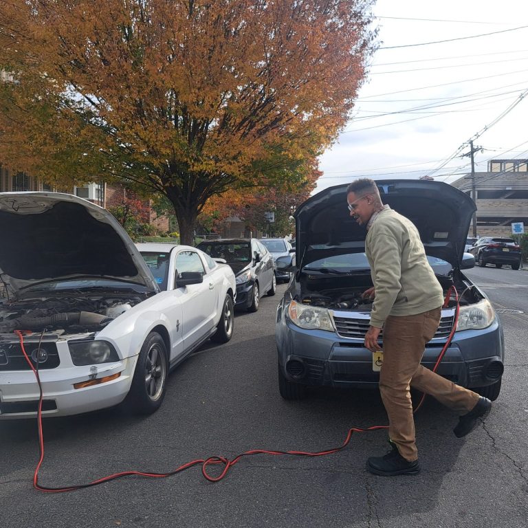 jump start in kearny NJ Happy road services tech doing a battery Jump start in kearny NJ