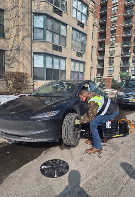 24/7 Roadside assistance in Hoboken NJ performing a tire change Happy road services performing a Tire Change / Tire Repair In Hoboken NJ , Also Serving Entire Hudson county