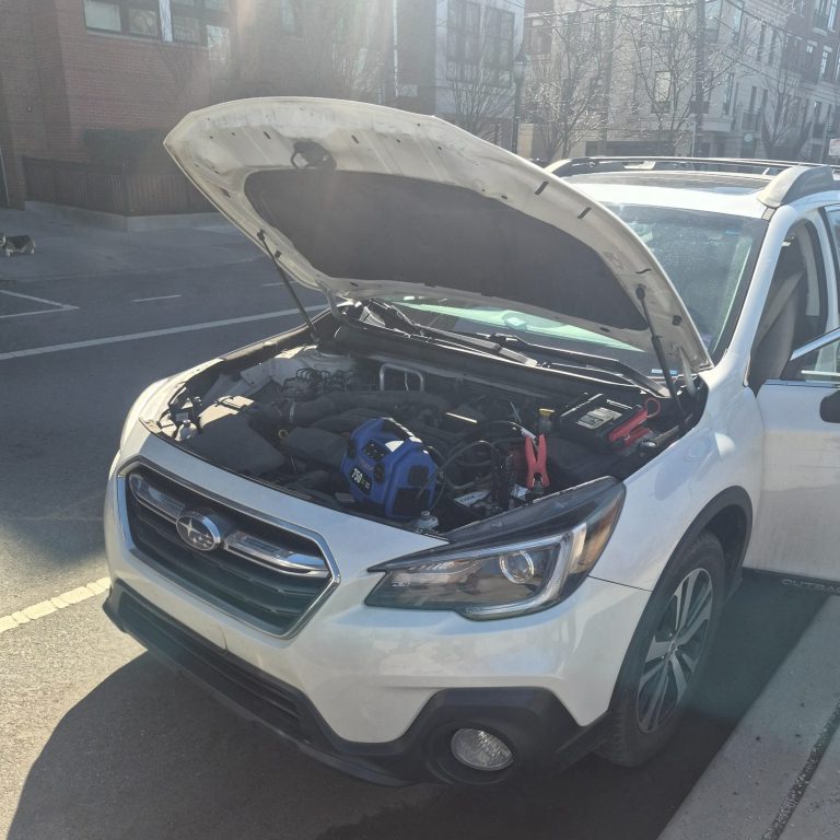 Battery jump start in Hoboken NJ Roadside assistance doing a jump start on a car battery in Hoboken NJ